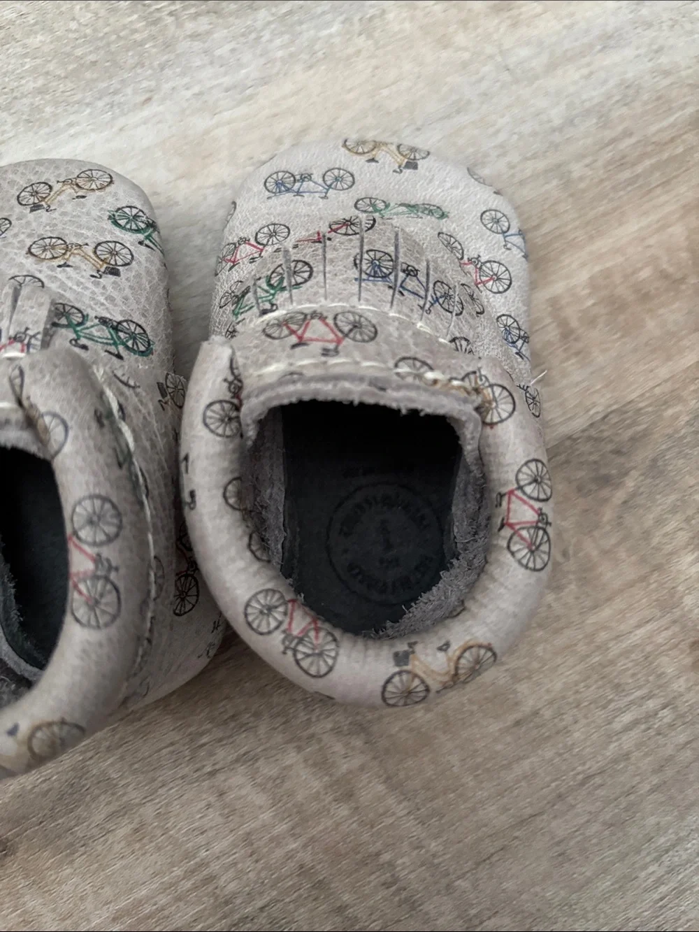 Freshly Picked Beige Baby Moccasins with Multicolor Bicycle Print